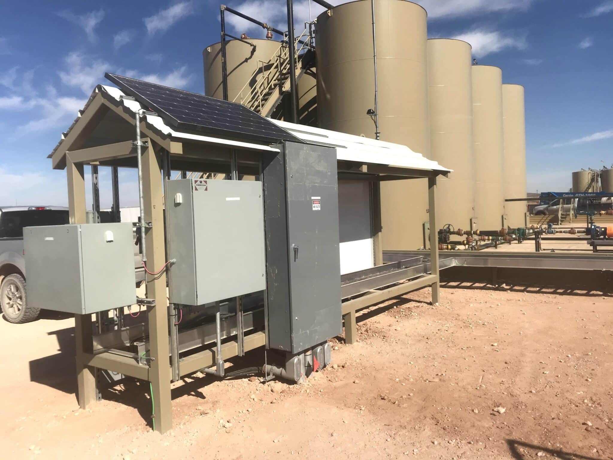Small electrical hut with solar panels on jobsite