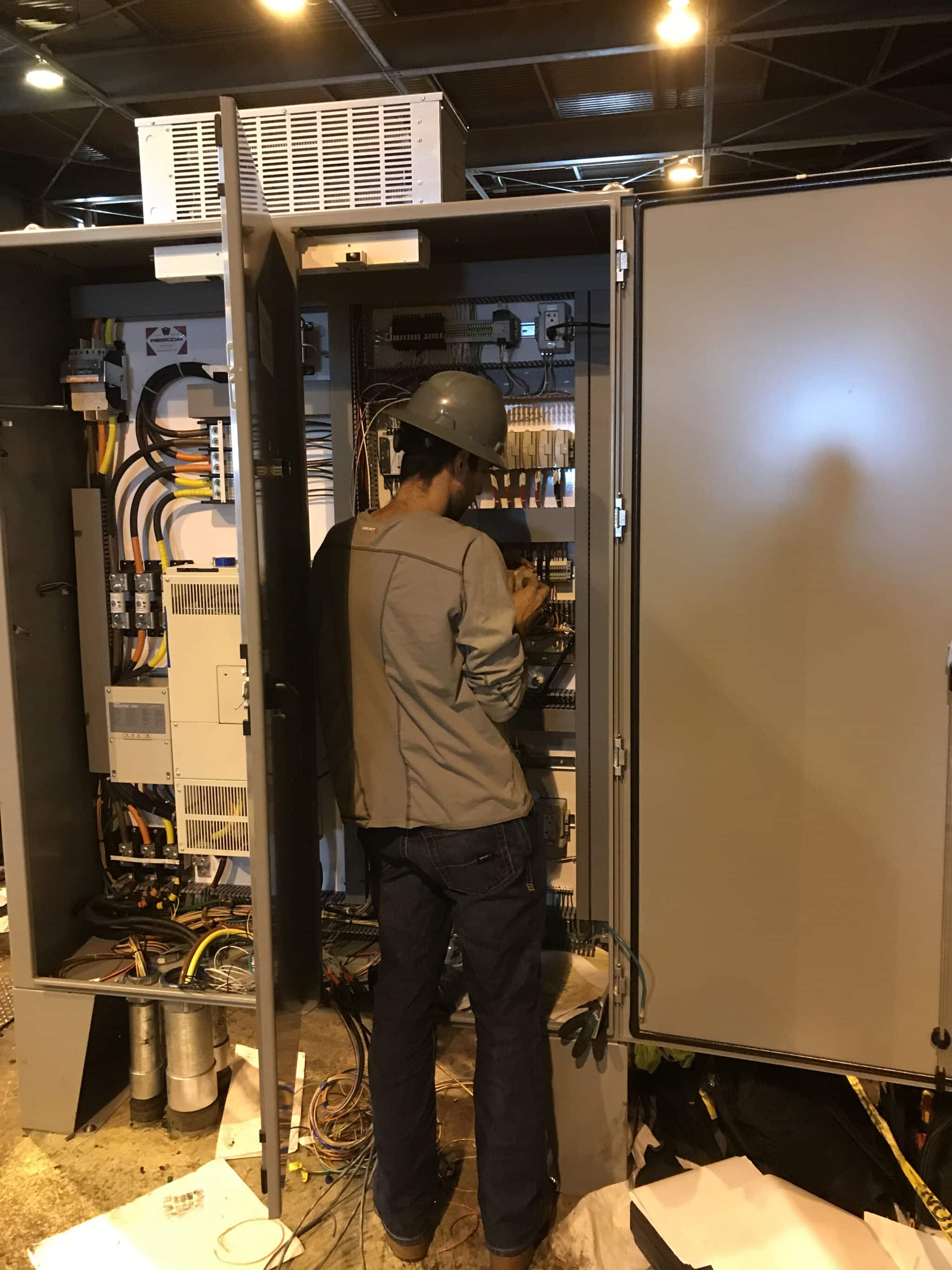Man working on two electrical boxes