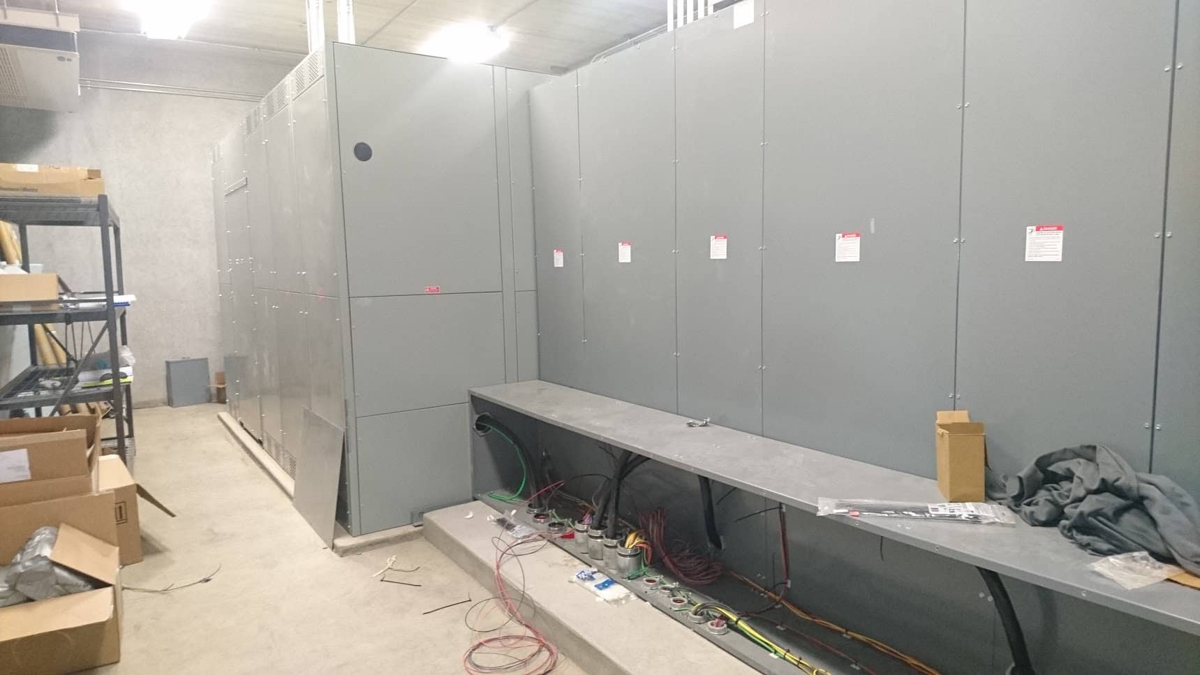 large gray panels to conceal electrical work in concrete room