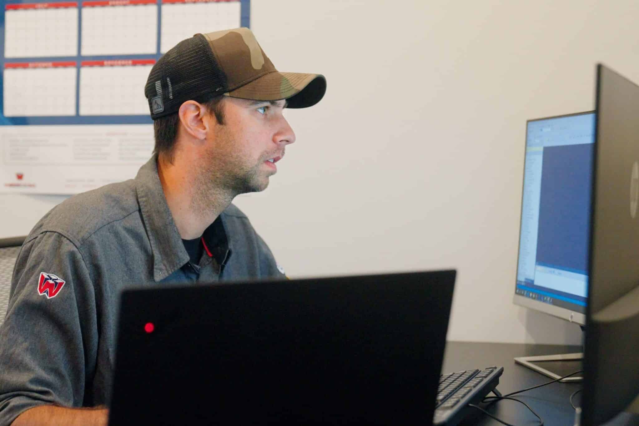 Wescom employee named Calvin looking at computer screen