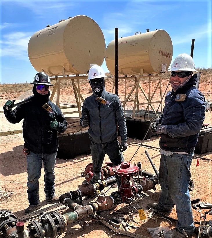 Three men in New Mexico doing roustabout service work