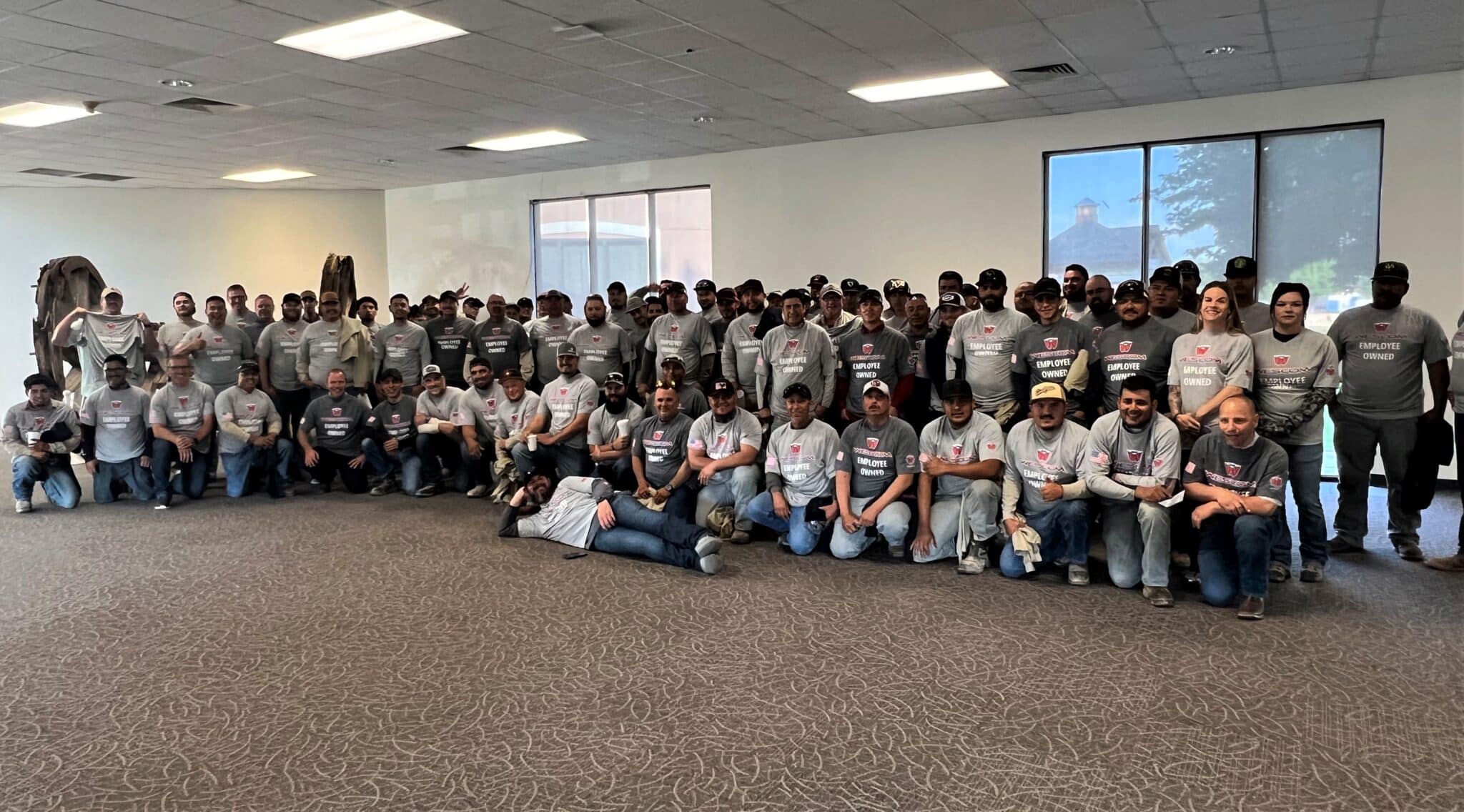 A group of Permian Wescom employees wearing their new "Employee-Owned" themed t-shirts