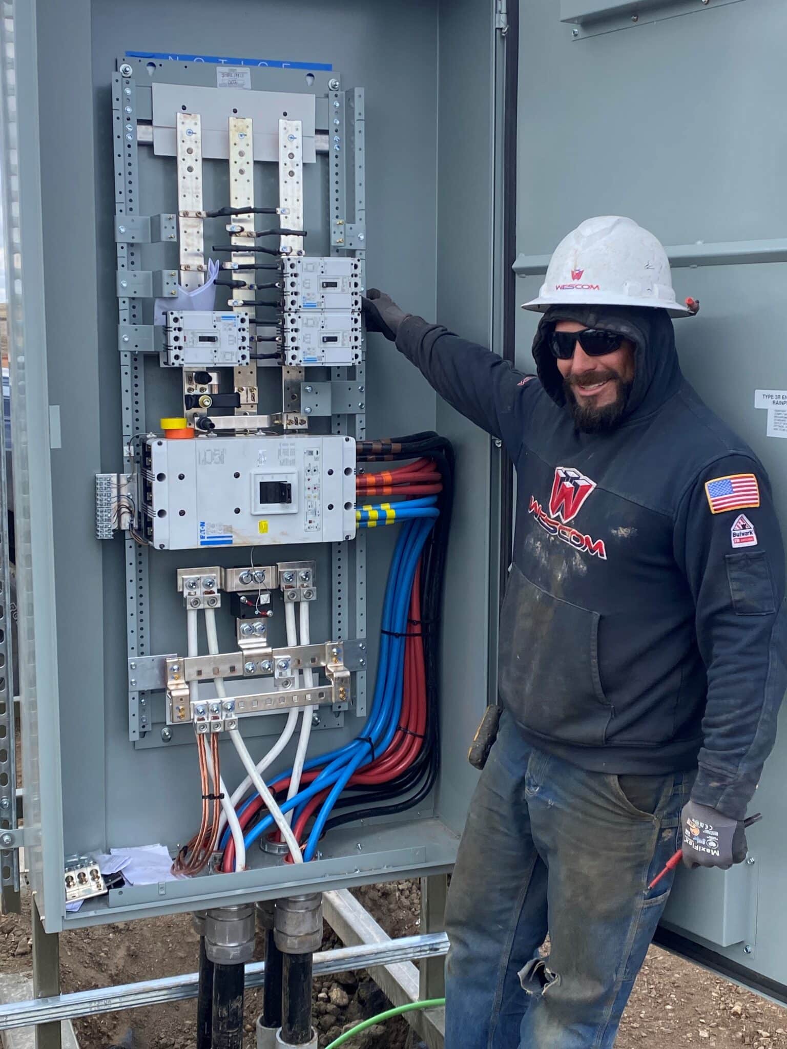 field electrician wiring a large panel
