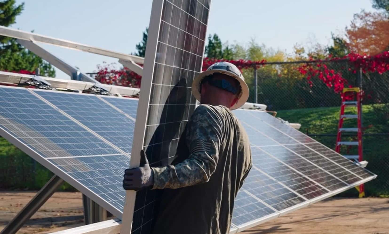 Cory carrying solar panel